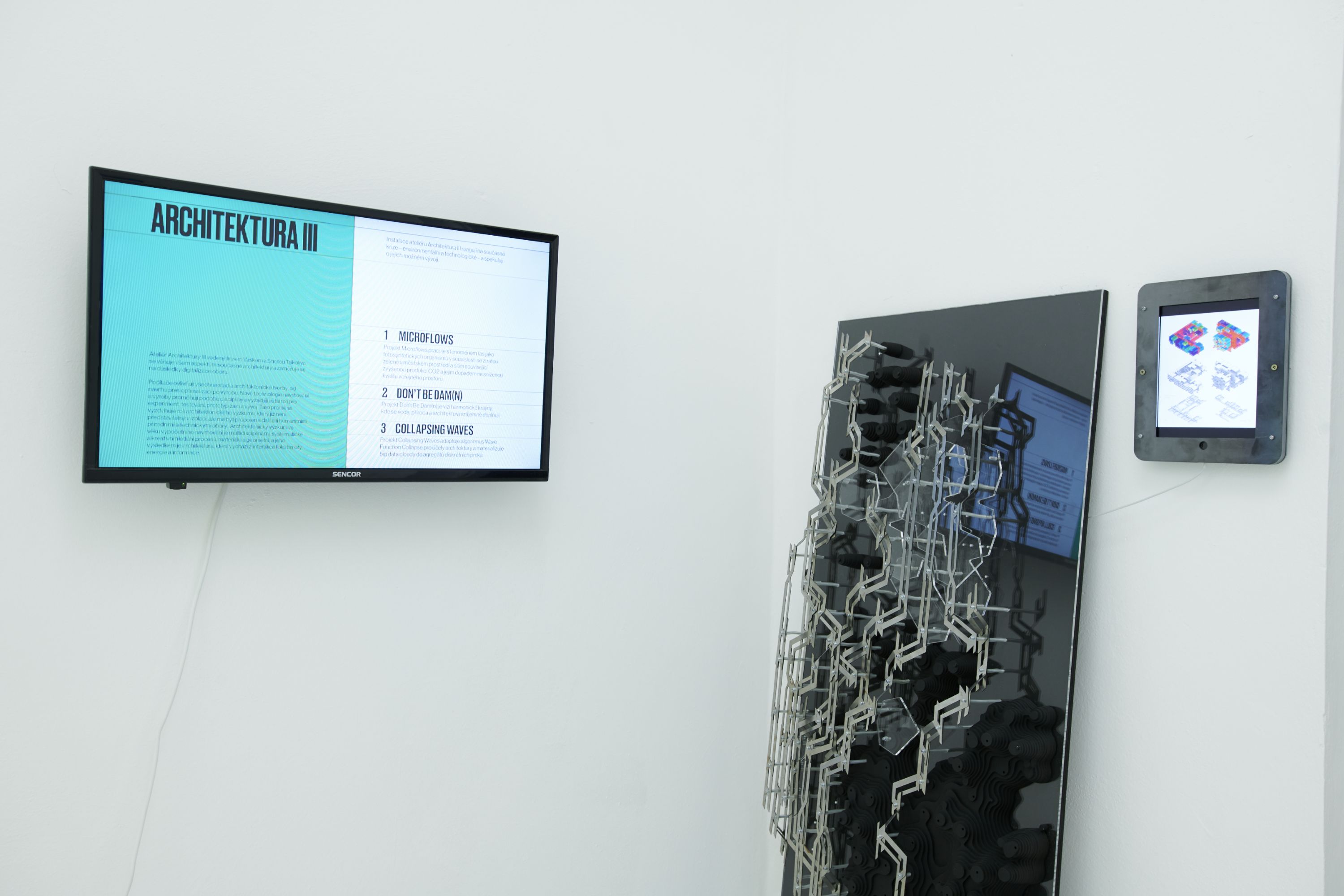 Exhibition wall with display screen, wall-mounted multi-material aggregation model on mirror, and tablet