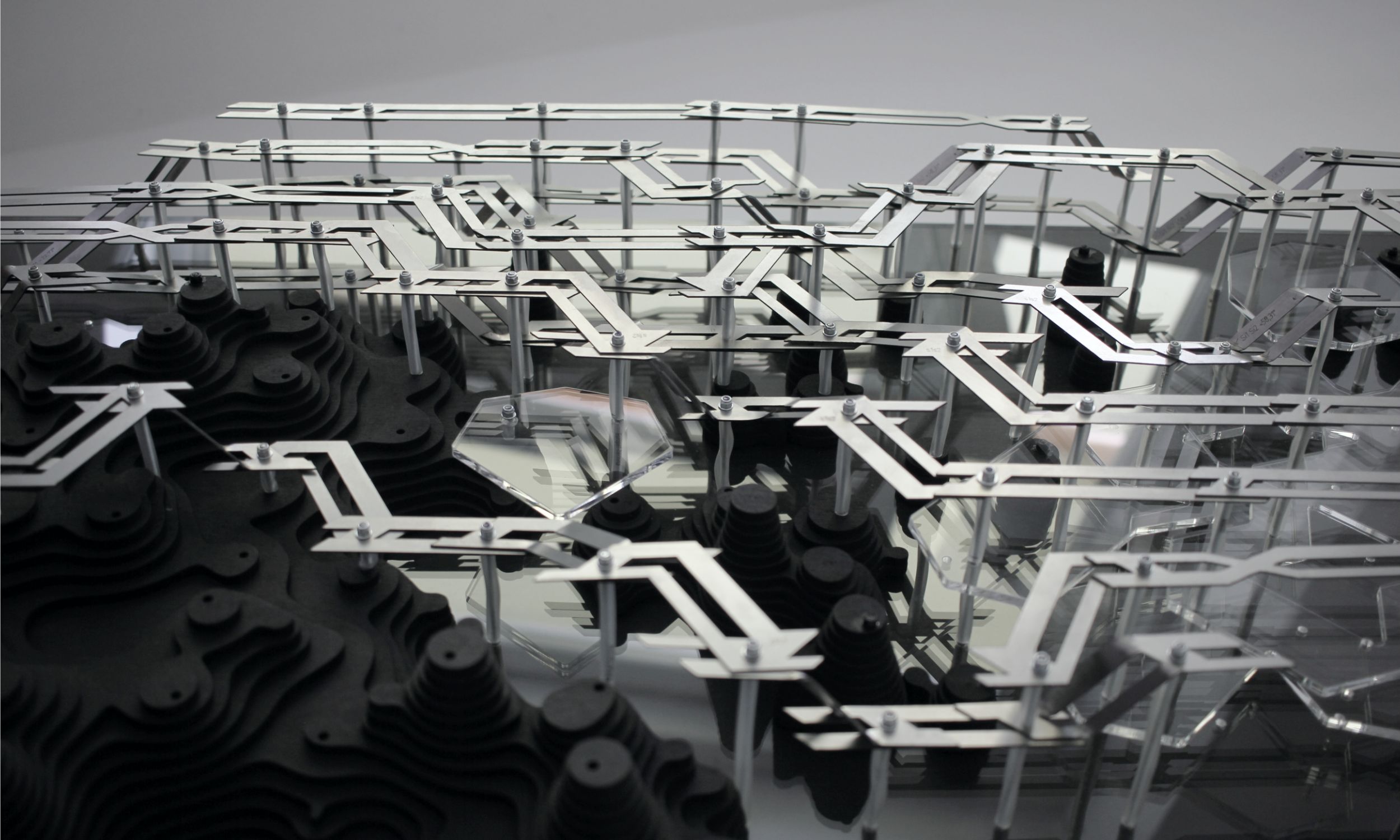 Physical prototype with stacked plywood wood modules and metal framework viewed from above